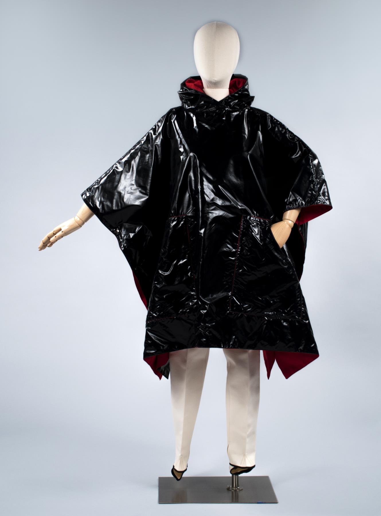 Image of Black, glossy plastic poncho with stretch pants, worn as part of the Seattle World's Fair Century 21 Fashion Show, 1962